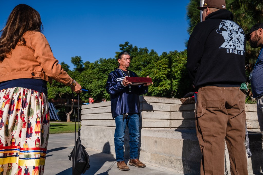 Bobby Wallace of the Barona Band of Mission Indians holds the Kumeyaay flag at San Diego Unified in University Heights on Nov. 3, 2023.
