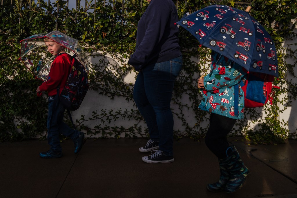 Henry Cole, 5 years old (left) and Rhett Sammons, 4 years old, (center) both UTK students, walk to Stephen C. Foster Elementary School with their mothers on Jan. 30, 2023.