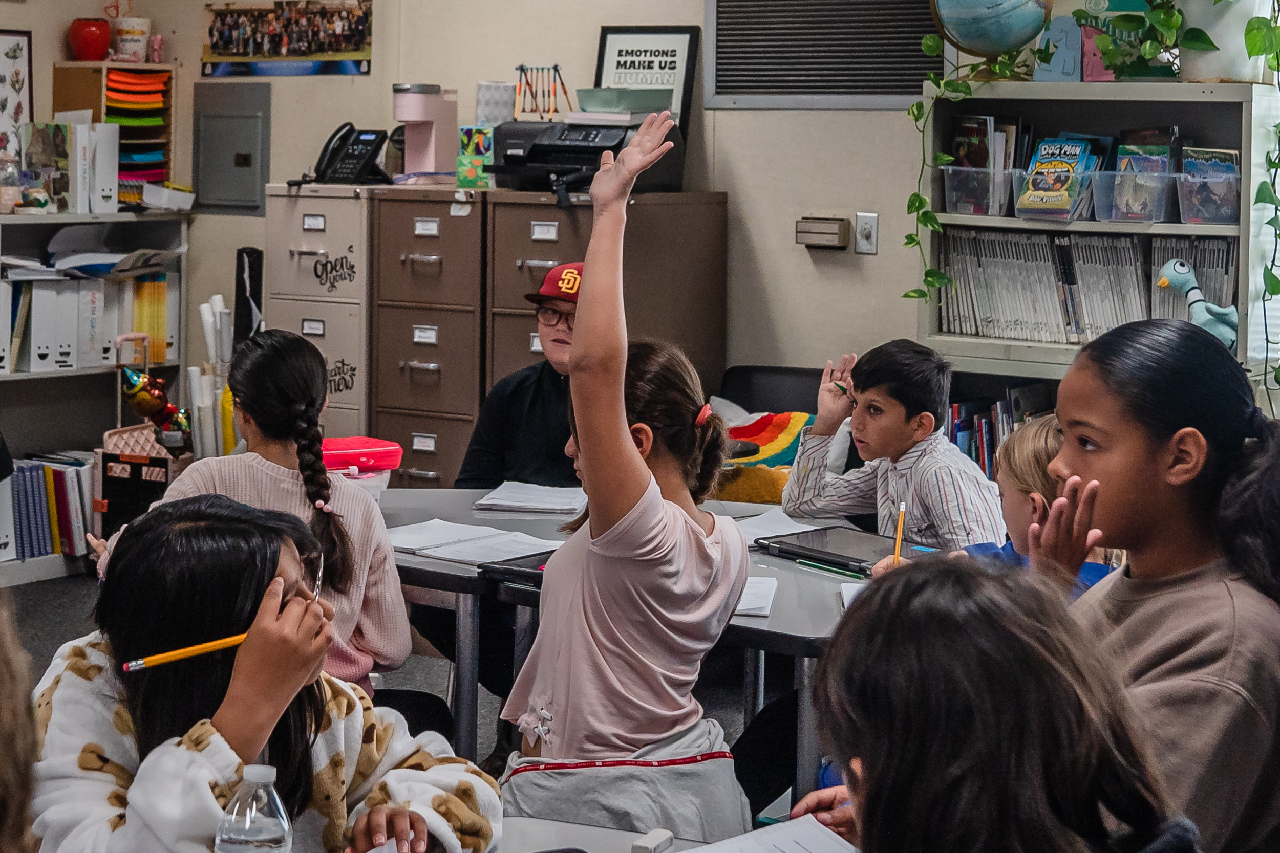 Fifth graders raise their hands while working on a class assignment at Madison Elementary School in El Cajon on Nov. 9, 2023.