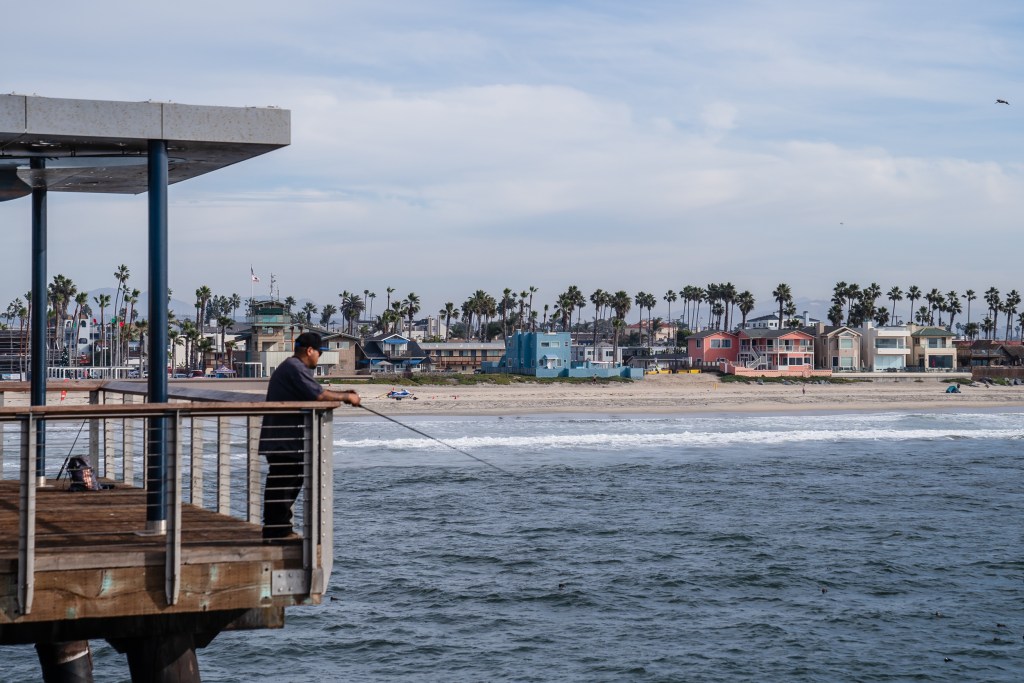 A man fishing from the Imperial Beach Pier on Dec. 4, 2023.