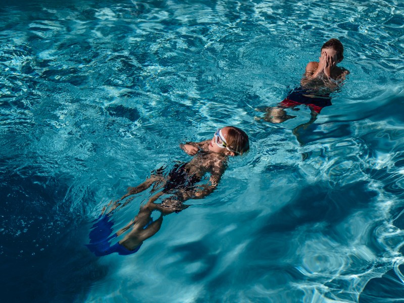 Brothers Graeson, 12 and Owen Shields, 7 take a pool break in Vista on Dec. 5, 2023.