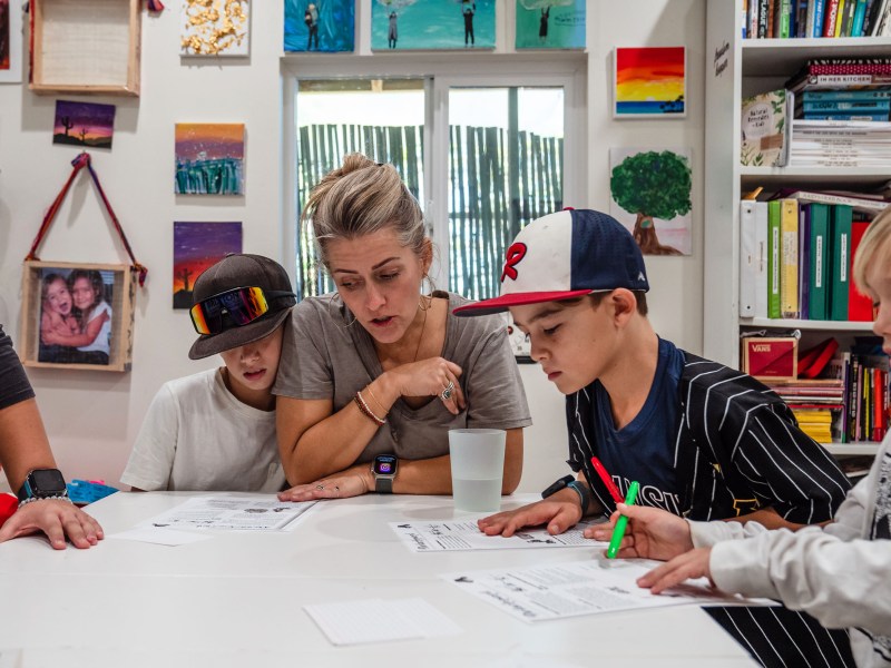 Sara Shields with her son Graeson, 12, Owen Shields, 7 and Jax Loy, 9 during a Virtues and Detachment lesson that Suzette Loy (noti pictured) is teaching in Vista on Dec. 5, 2023.