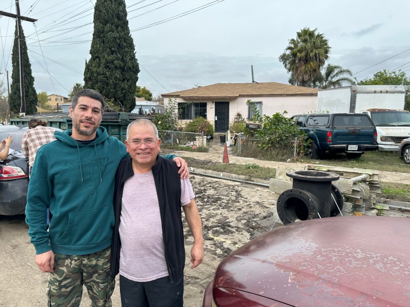 Jesse Preciado, 37, of Shelltown embraces Ignacio Gonzalez, 61, who he rescued from the floodwaters invading his home on Jan. 24, 2024. / MacKenzie Elmer