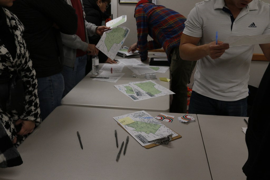 Organizers with the Regional Task Force on Homelessness hand volunteers maps of Vista for the annual point-in-time count on Thursday, Jan. 25, 2024. / Photo by Tigist Layne