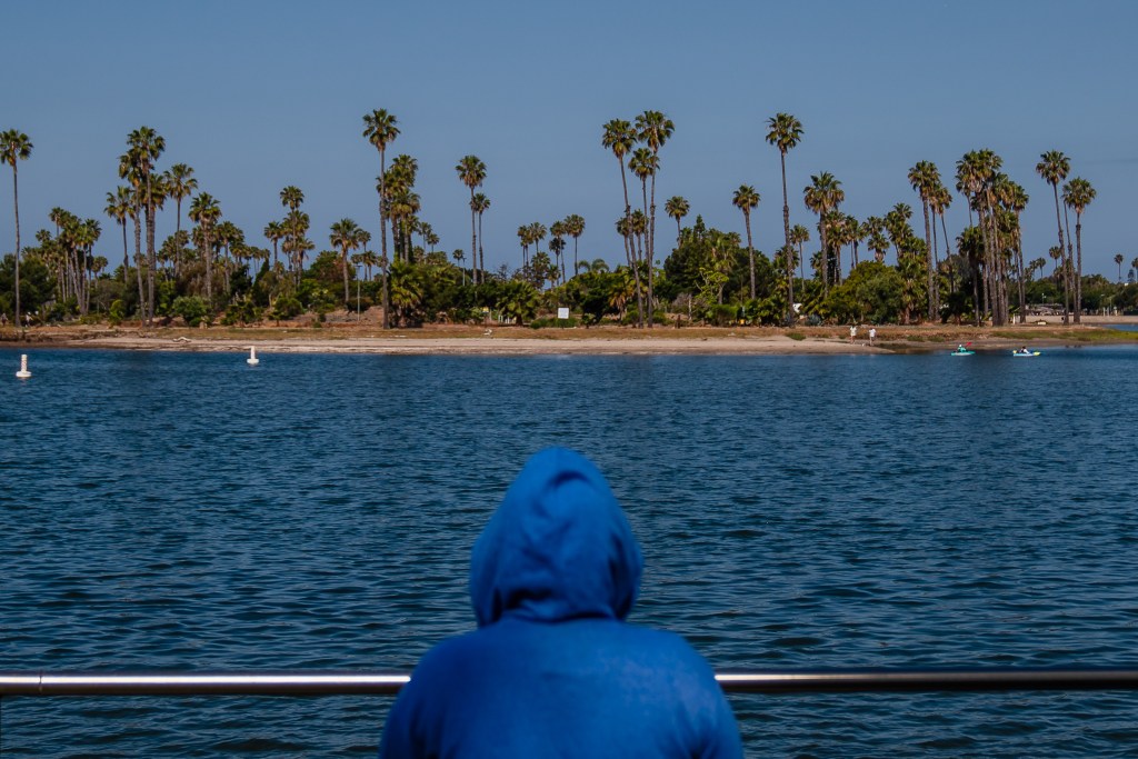 A woman in a hoodie on May 21, 2024, in San Diego. / Photo by Ariana Drehsler for Voice of San Diego