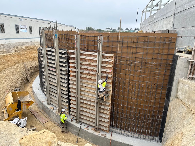 Workers erect a massive retaining wall at the city of San Diego's new Pure Water facility on June 11, 2024. / MacKenzie Elmer