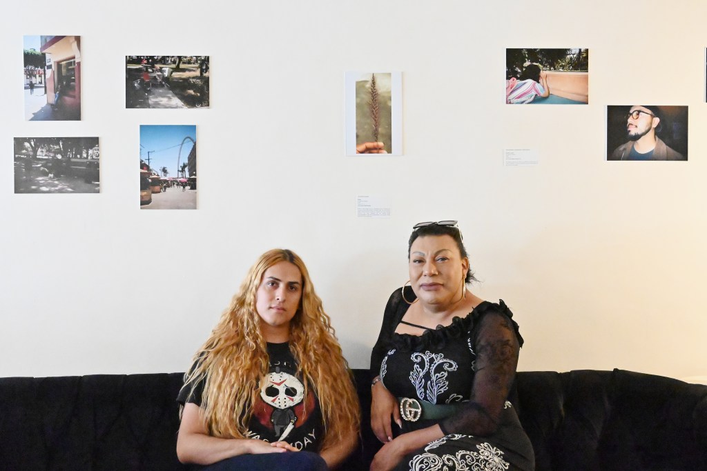 Al Otro Lado’s LGBTQ+ programs coordinator, Brigitte Baltazar Lujano (left), and Susana Barrales, the director of La Casita de Unión Trans which houses Trans asylum seekers in Tijuana, Mexico pose for a portrait at photographic exhibition made by trans women to empower each other at Avenida Revolucion’s Teorema Brewing on Friday, Aug. 9, 2024. Photo by Carlos A. Moreno for Voice of San Diego