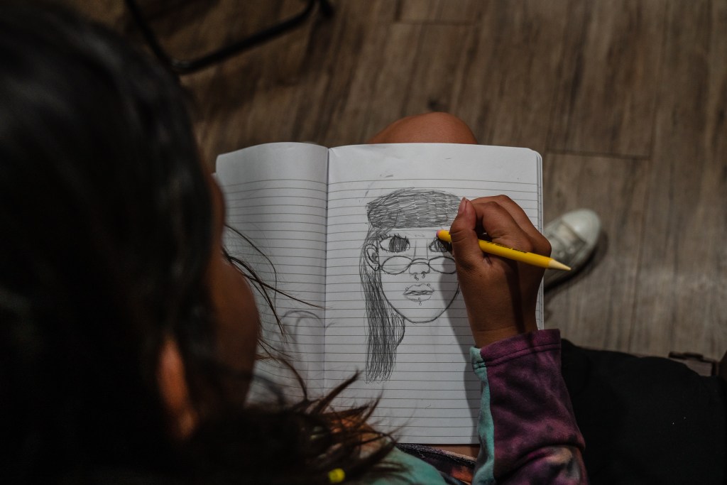Jose and Mercedes’ 10-year-old daughter drawing at Interfaith’s Hawthorne Veteran and Family Resource Center in Escondido on Thursday, Aug. 1, 2024. / Ariana Drehsler for Voice of San Diego