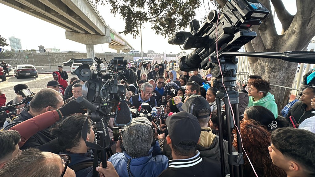 Jose Luis Perez Canchola, Tijuana's former director of migrant affairs, surrounded by migrants and members of the media on Monday, Jan. 20, 2025. / Photo by Alberto Elenes