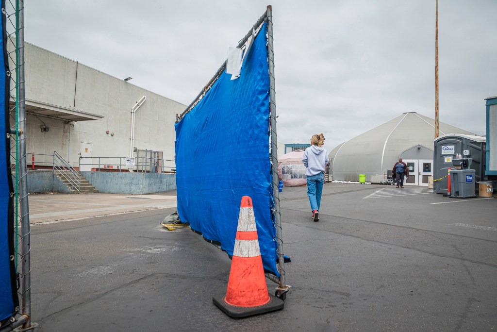 Two women walk outside the Rosecrans shelter in Midway on Tuesday, April 15. / Photo by Vito di Stefano for Voice of San Diego