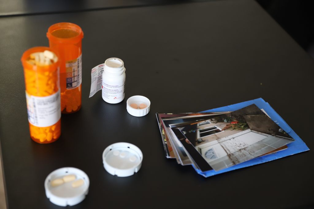 Silvia Valdivia Zubi's epilepsy prescriptions and photos of the flood line at her apartment's front door. / Rami Alarian